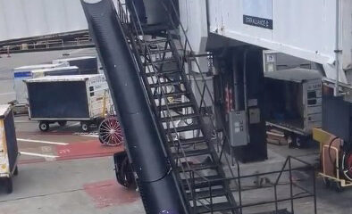 A gate agent throwing the luggage of a passenger on the ground at San Francisco Airport